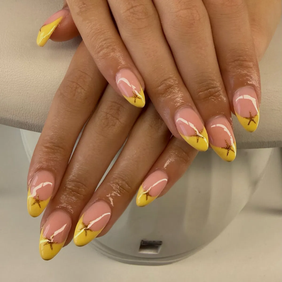 Yellow French tips with starfish motifs