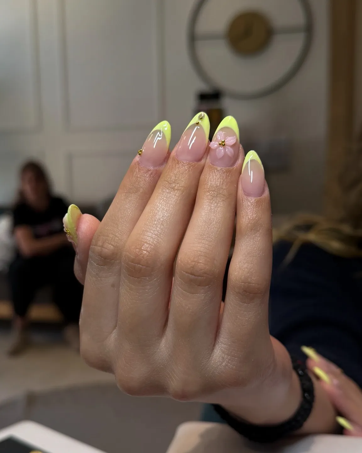 Neon yellow-green French tips with a raised pink flower accent