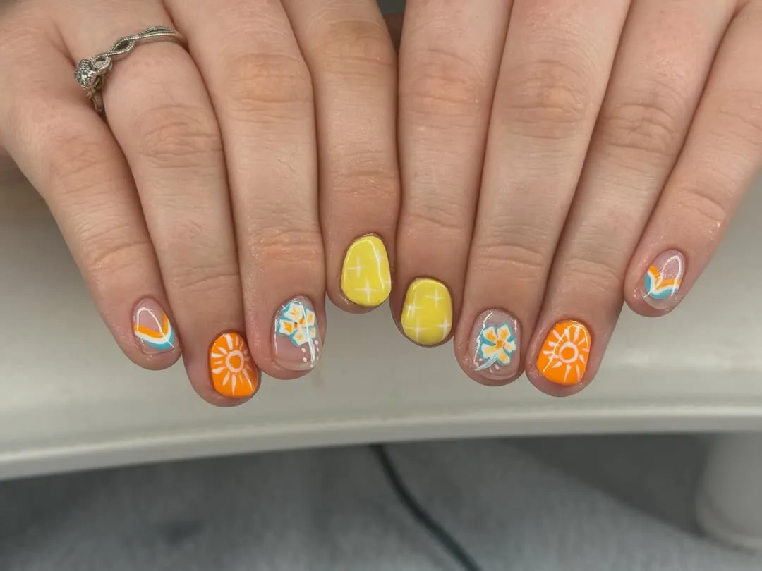 Pale yellow French tips with pink flower accents