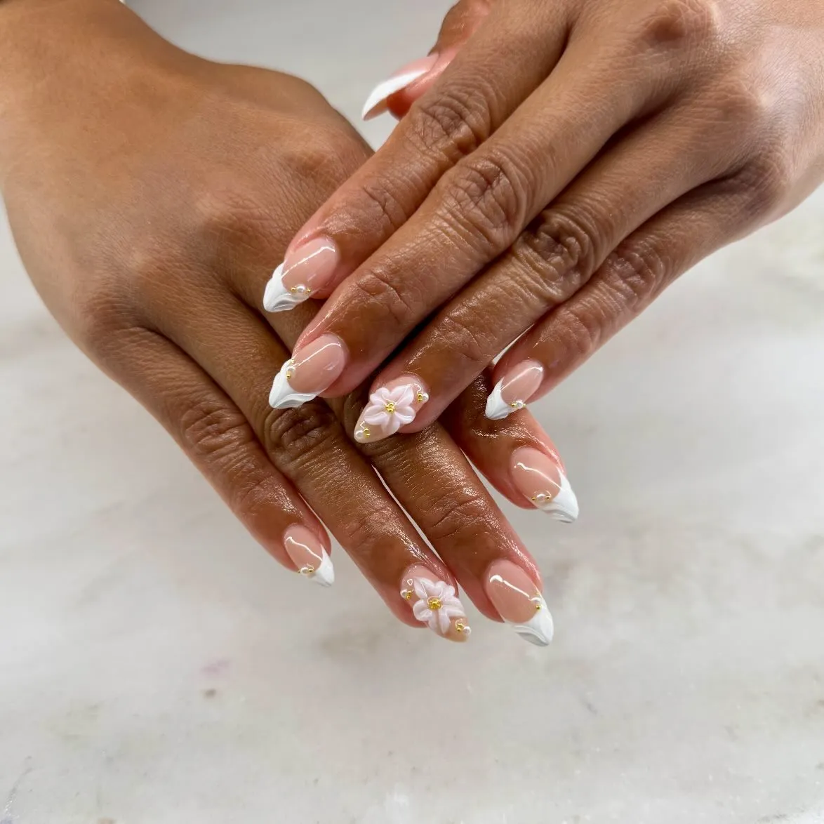 White French tips with raised floral accents and gold dots