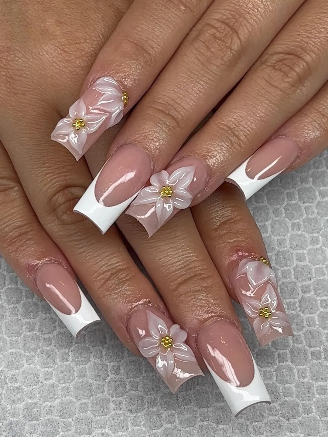 Bold white French tips with raised translucent flowers