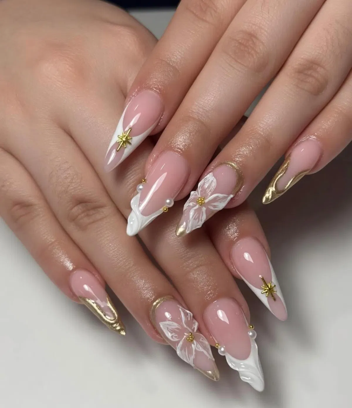 Gold star and pearl accents with white tips and floral detail