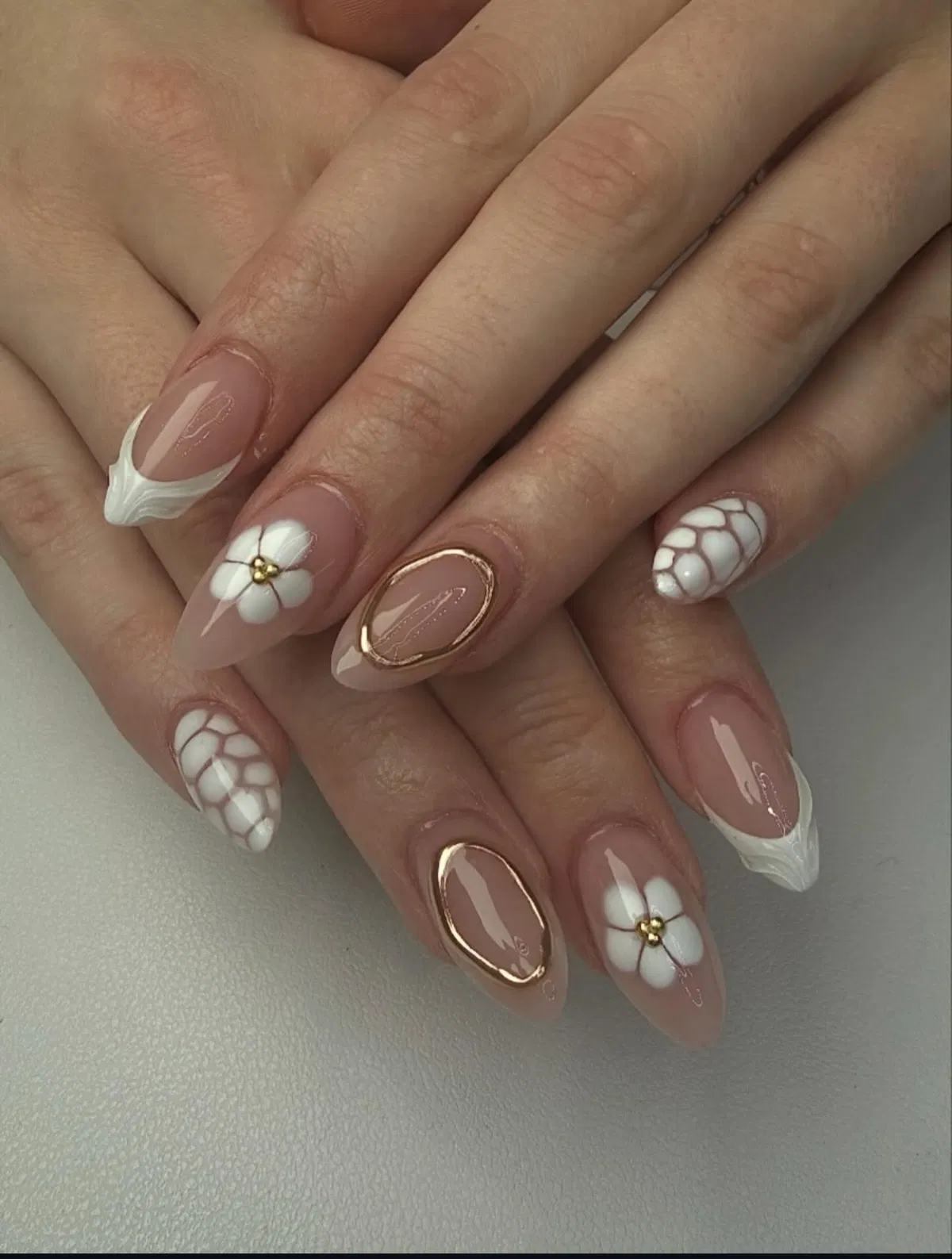 Mixed white florals, net pattern, and gold oval framing