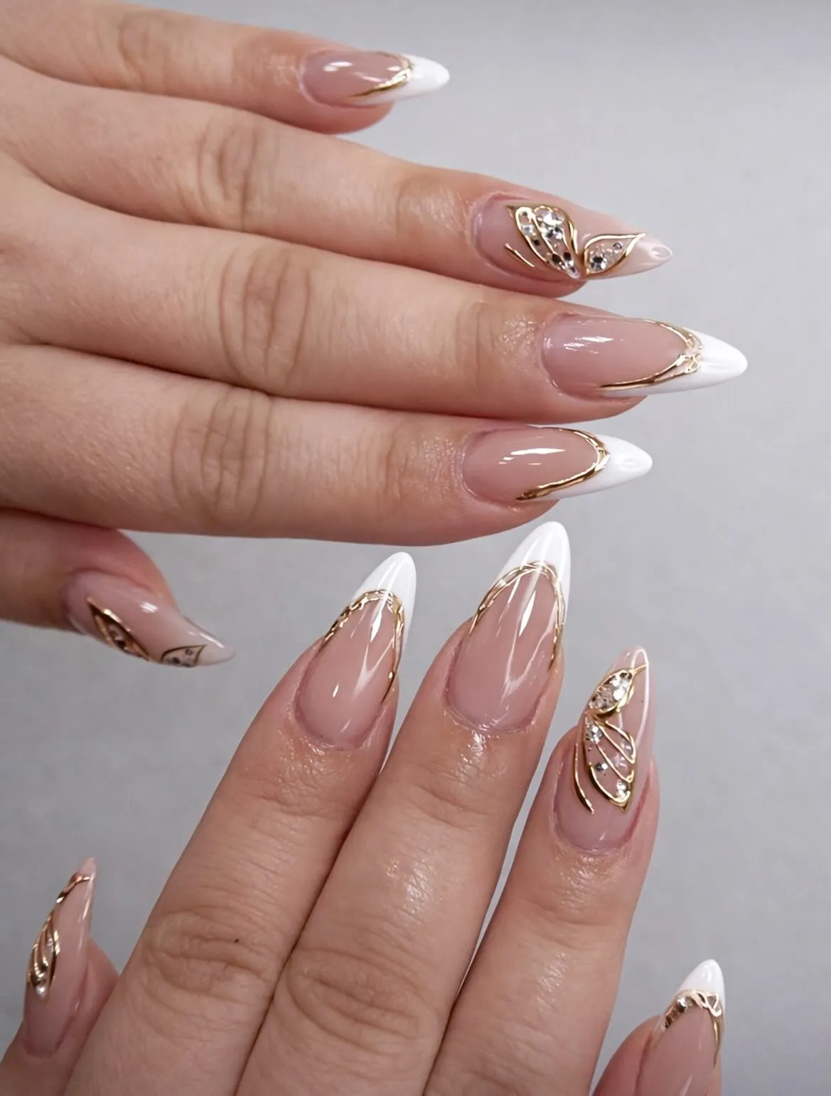 Gold-lined French tips with butterfly crystal accents