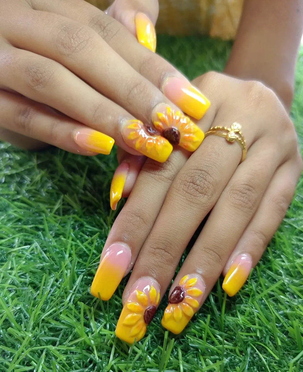 Glossy yellow ombrΓ© square nails with raised sunflower accents