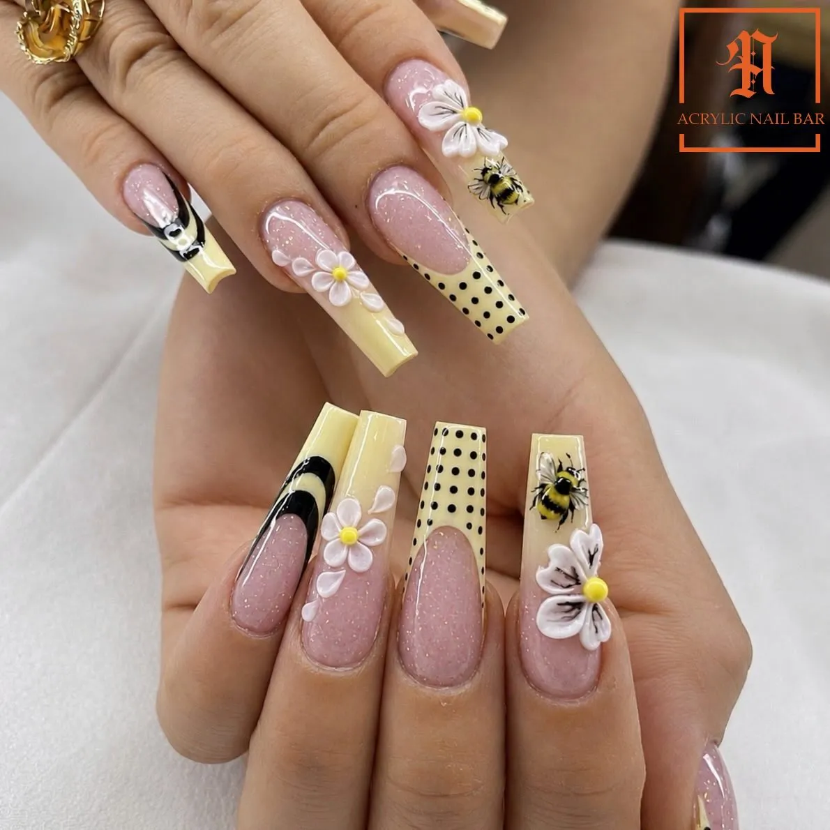 Pale yellow tips with 3D white flowers, polka dots, and bee art