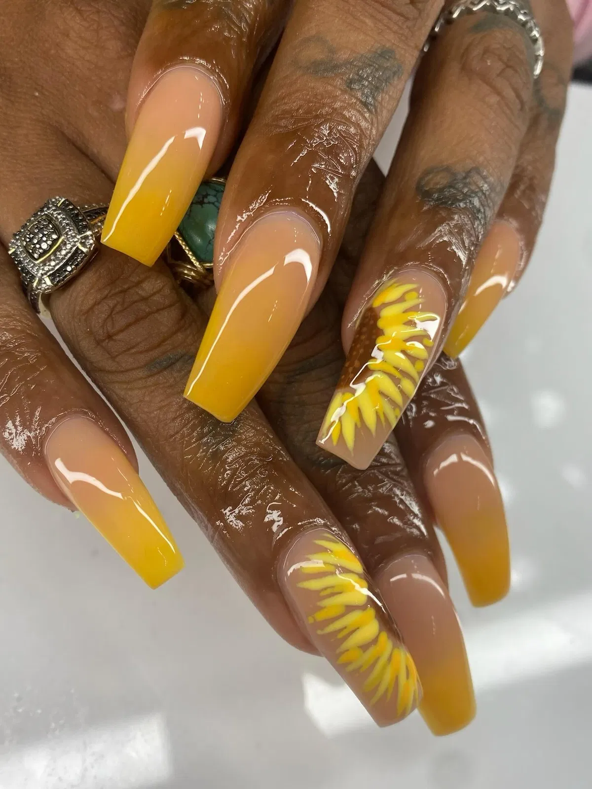 Yellow ombrΓ© coffin nails with petal-like accent art