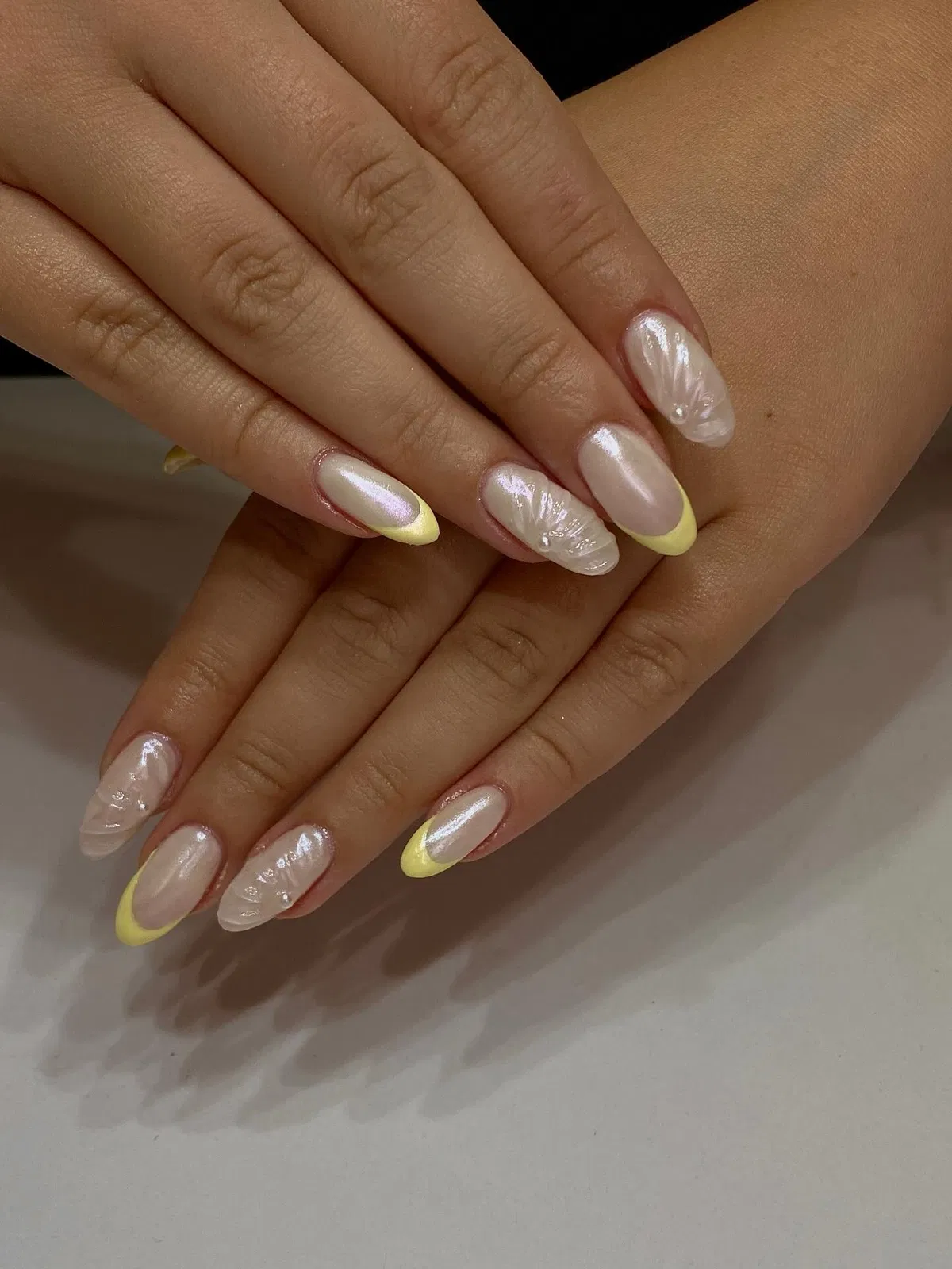 Pearl sheen with pale yellow tips and shell texture
