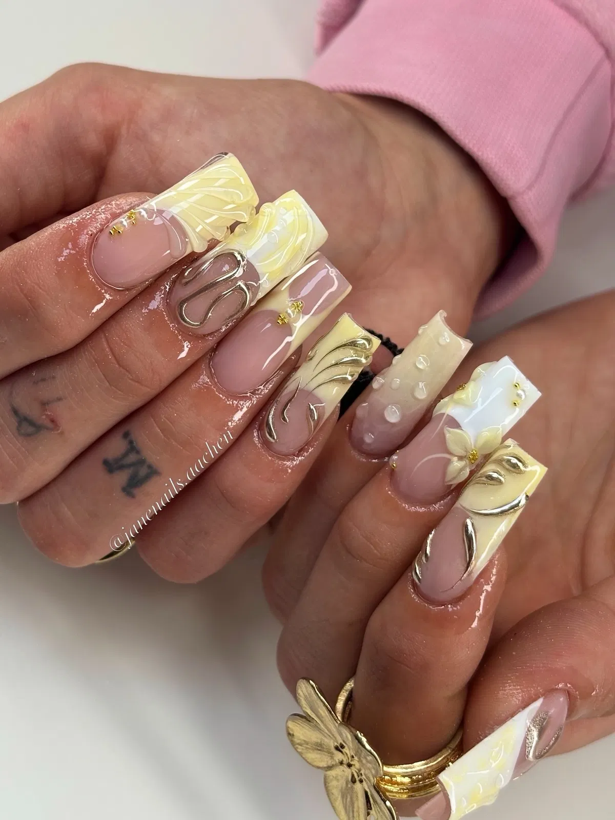 Creamy yellow swirls with raised silver outlines and floral accent