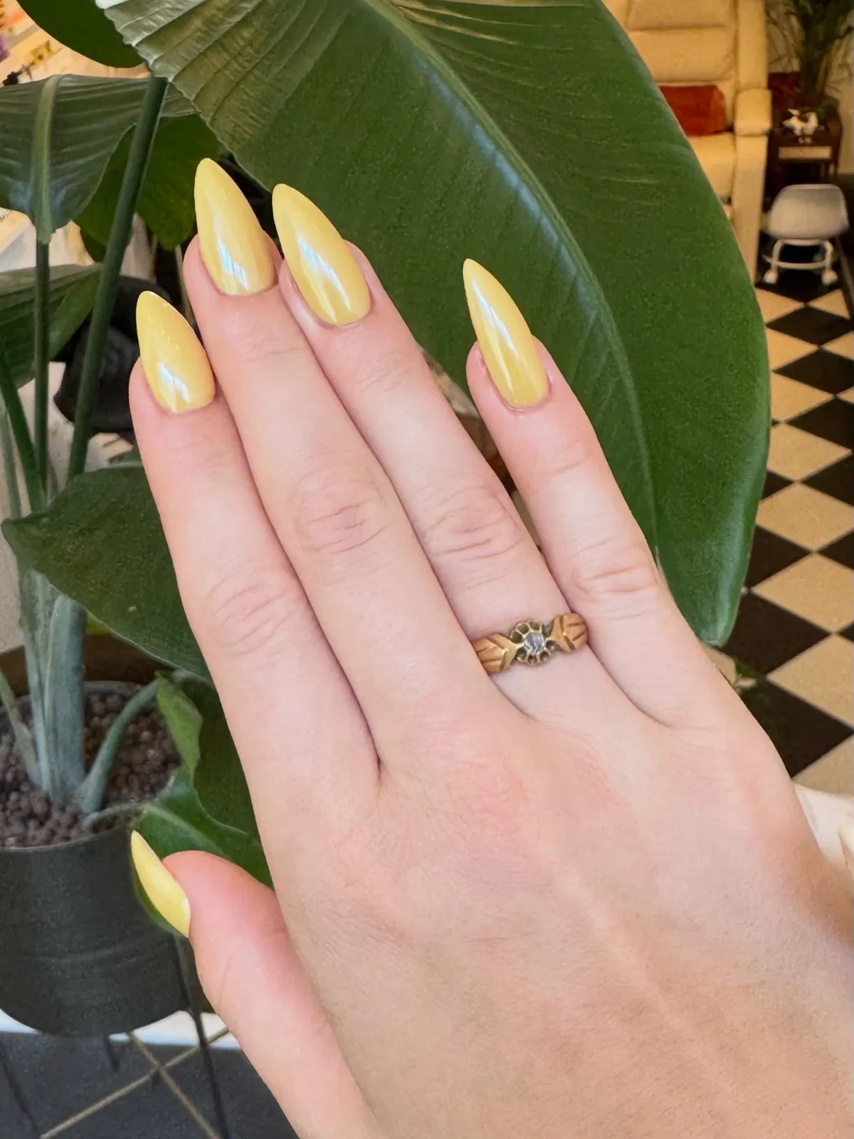Glossy yellow almond nails with reflective sheen