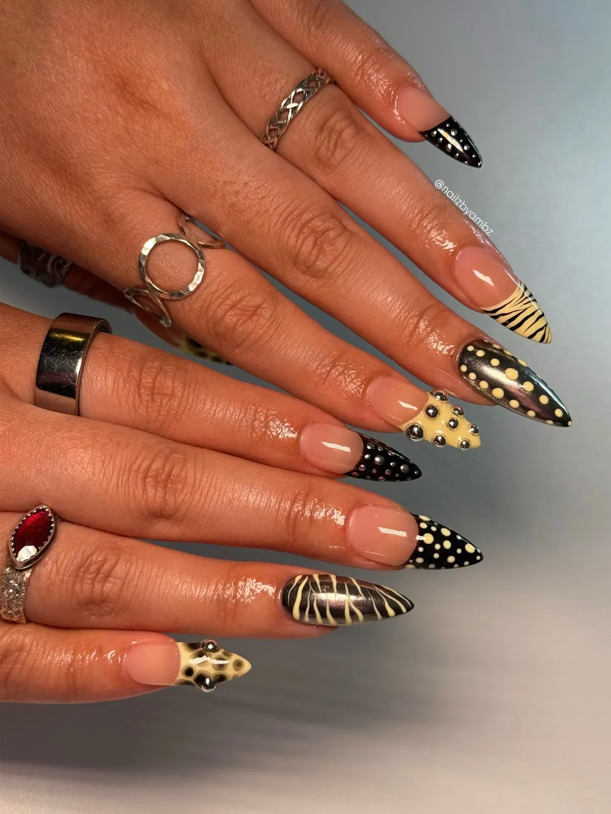 Graphic black-and-yellow patterns with studs and a raised star accent