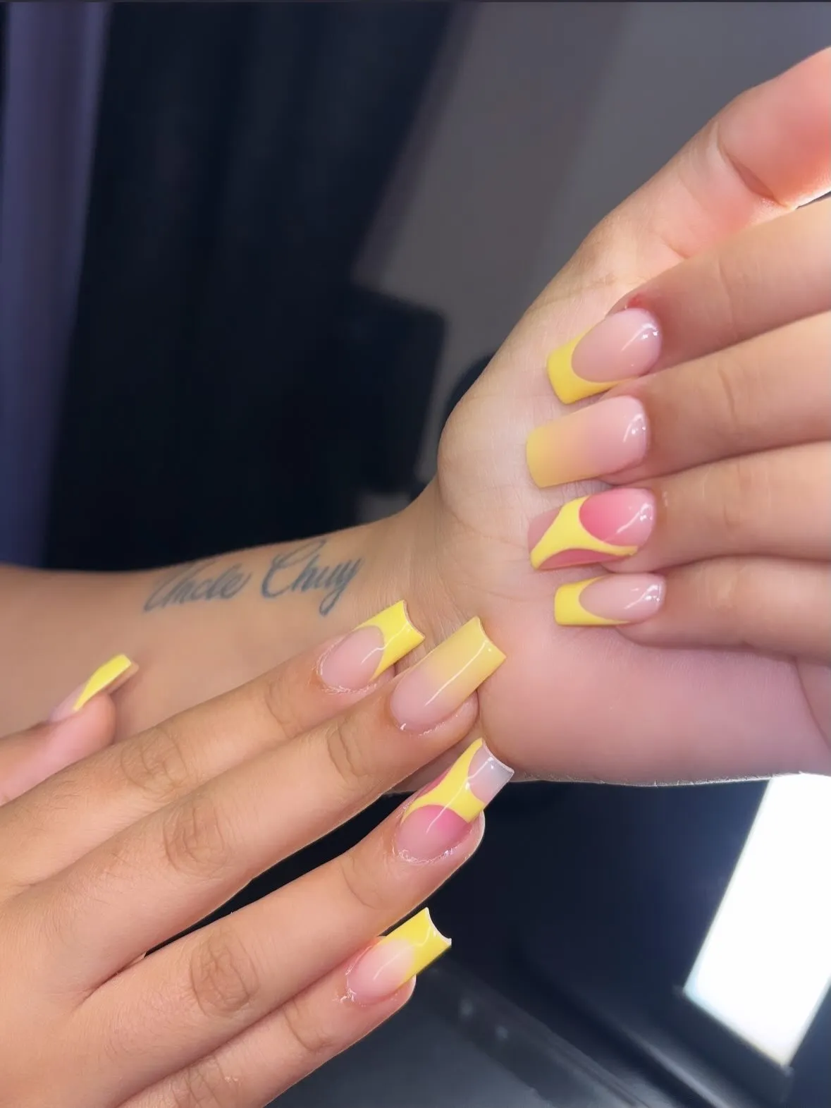 Curved yellow French tips with pink-and-yellow color-block accents
