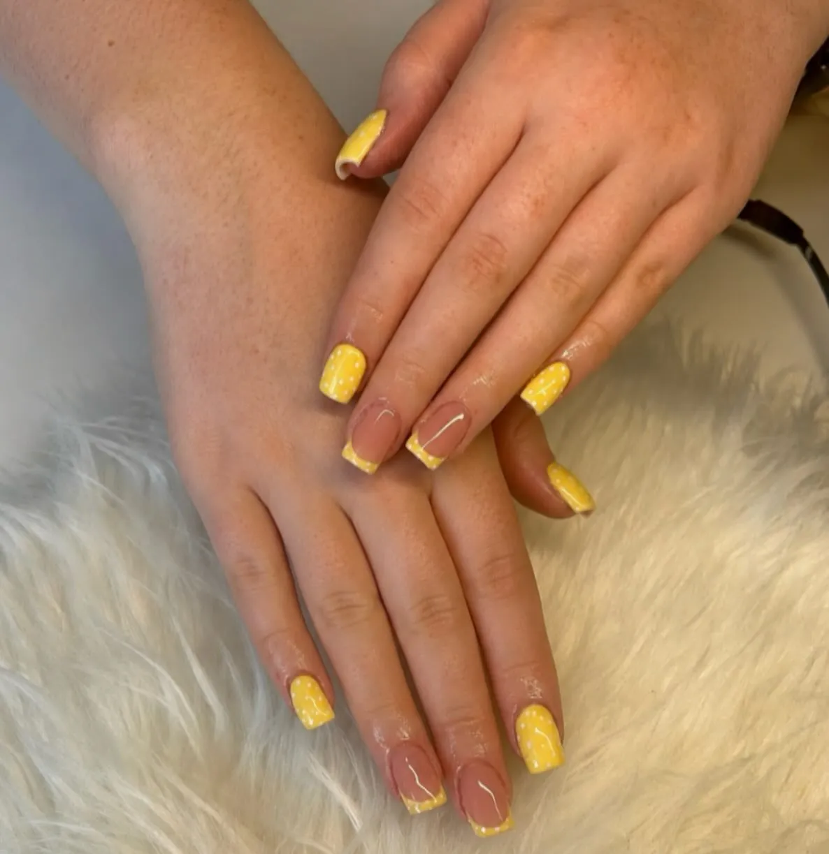 Yellow dotted nails paired with thin yellow French tips