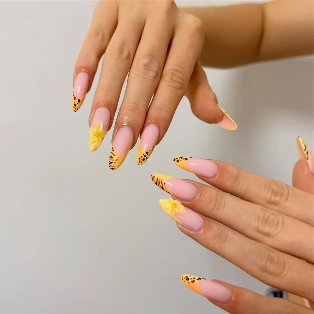 Yellow-orange French tips with black accents and 3D flowers