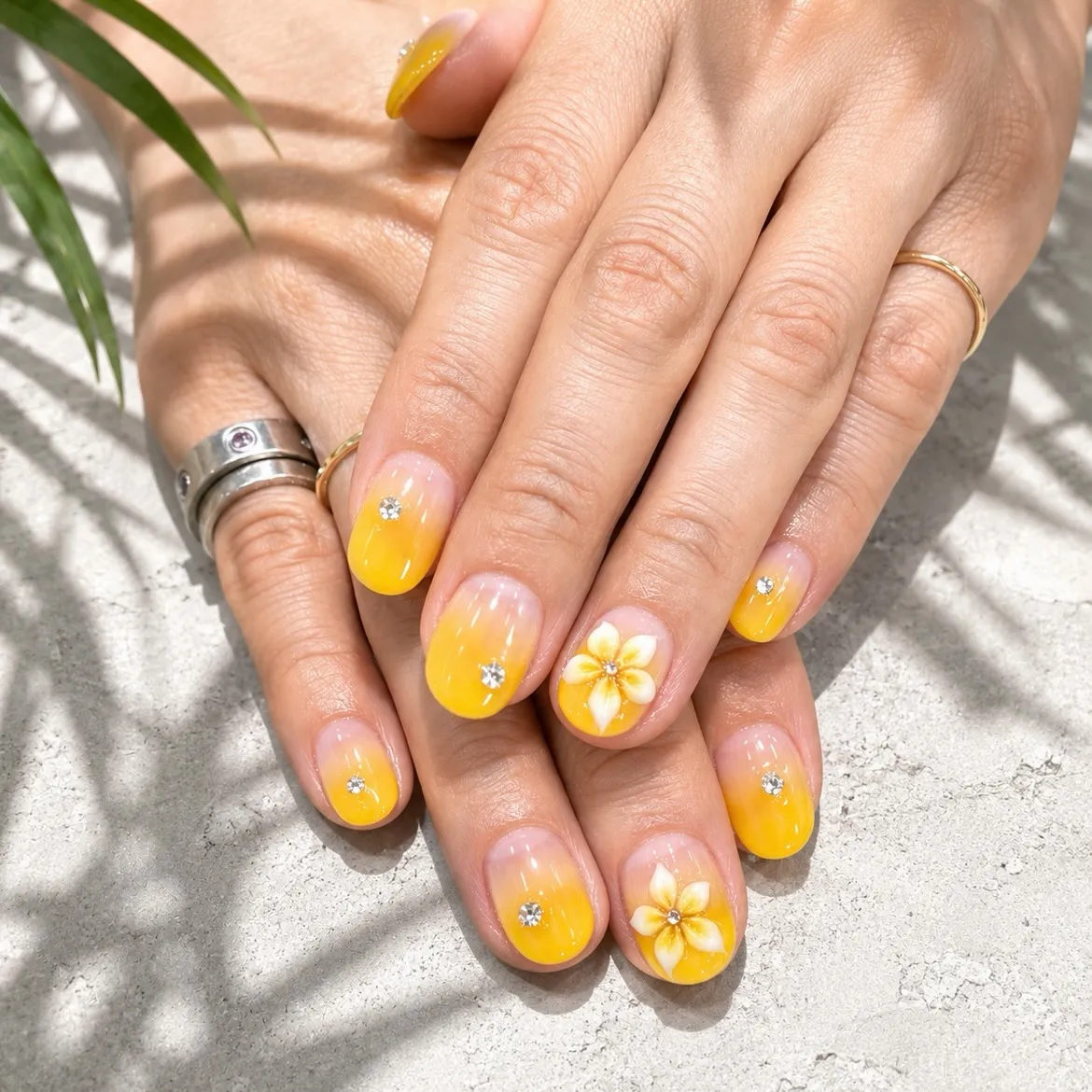 Short yellow ombre with small rhinestones and white flowers