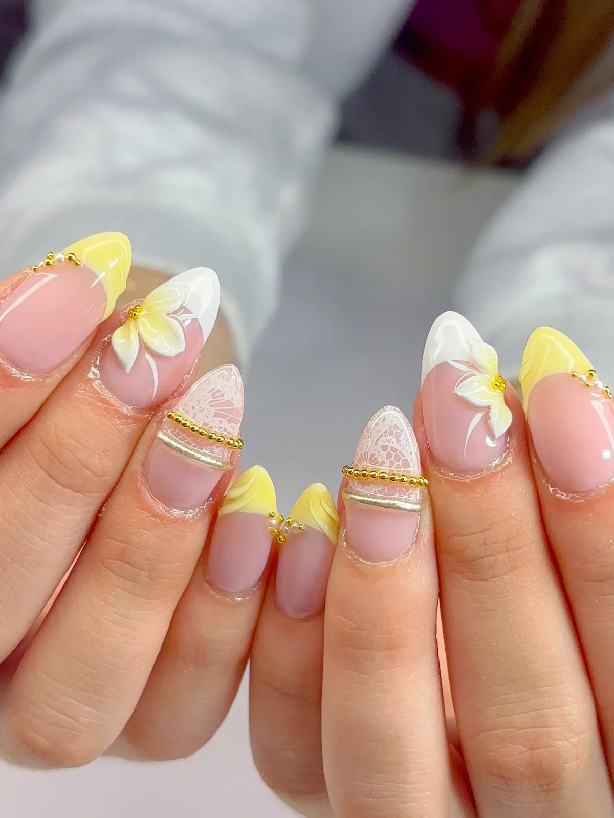 Elegant yellow-white tips with lace effect and bead accents