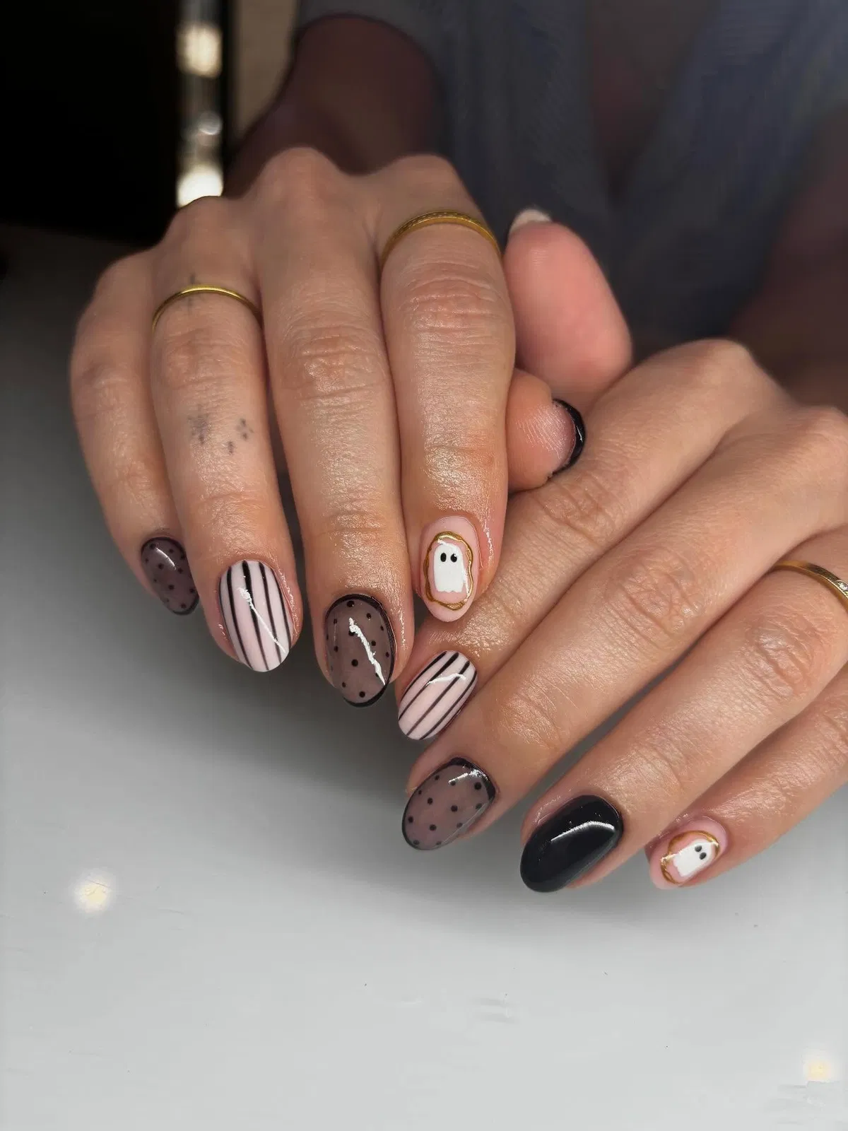 Neutral mix with stripes, polka dots, and a framed ghost accent