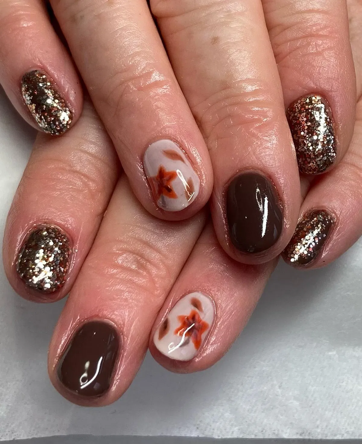 Dark brown and gold glitter with soft-focus leaf accents