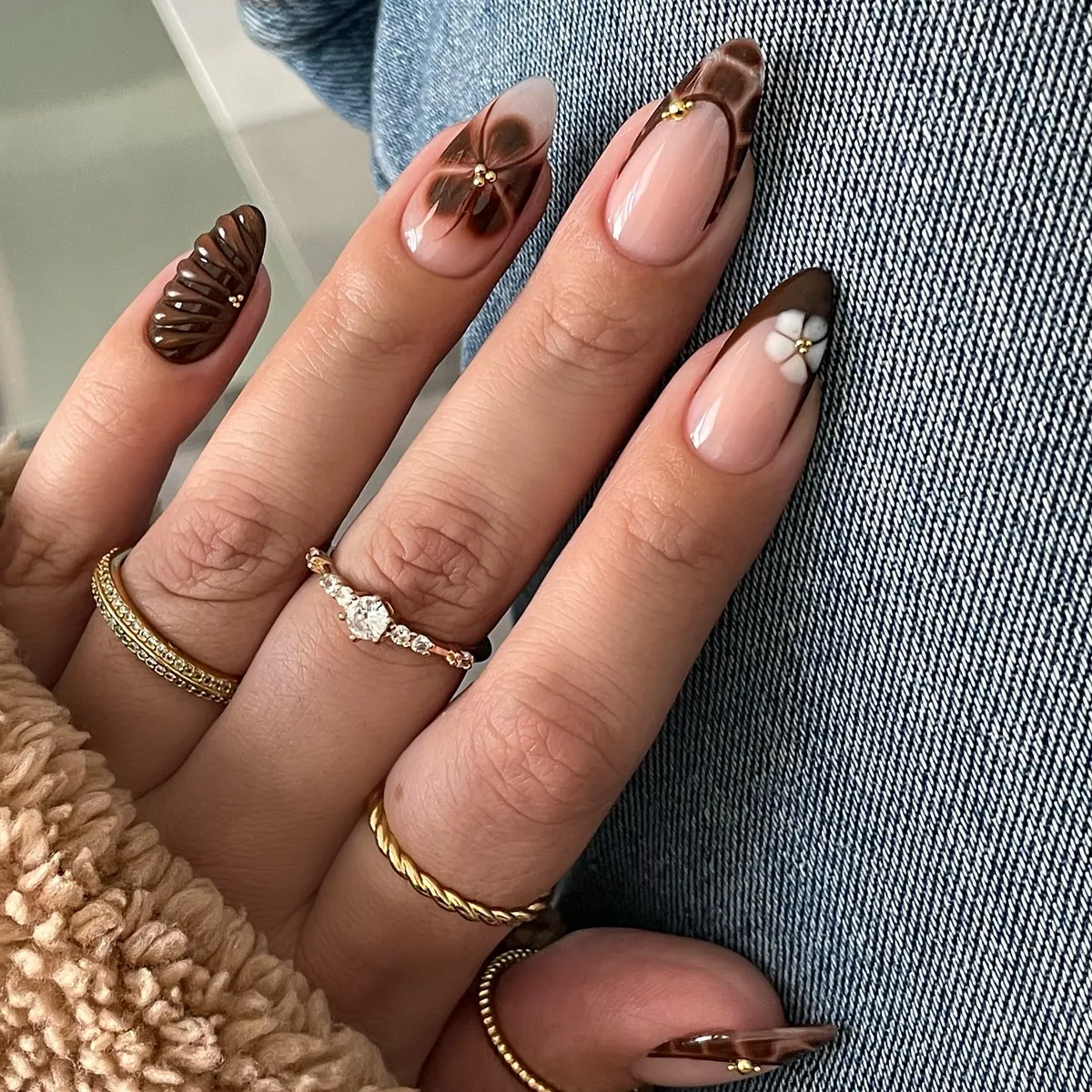 Brown French tips with 3D texture and a white flower