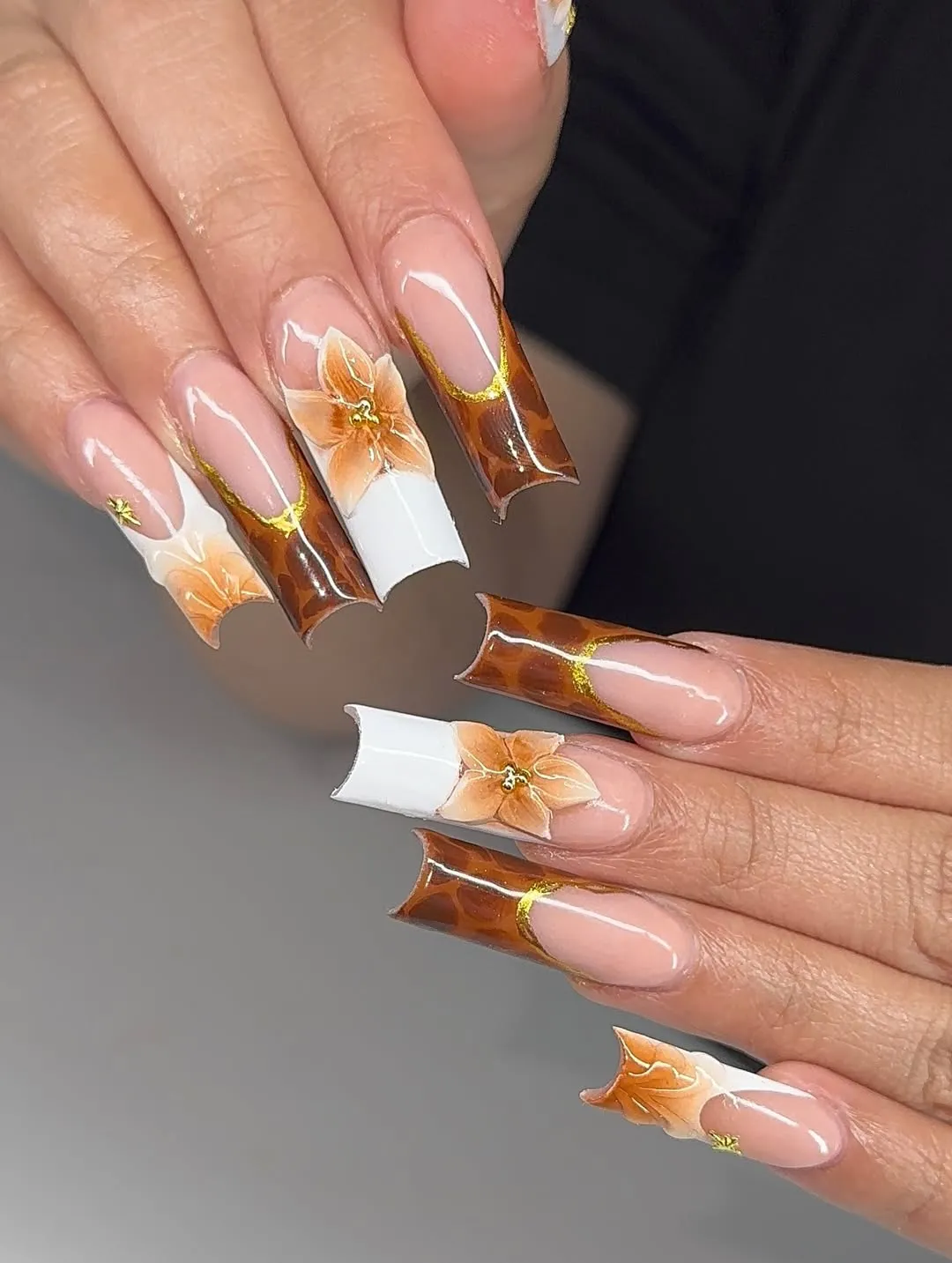Brown-and-white sculpted tips with orange florals