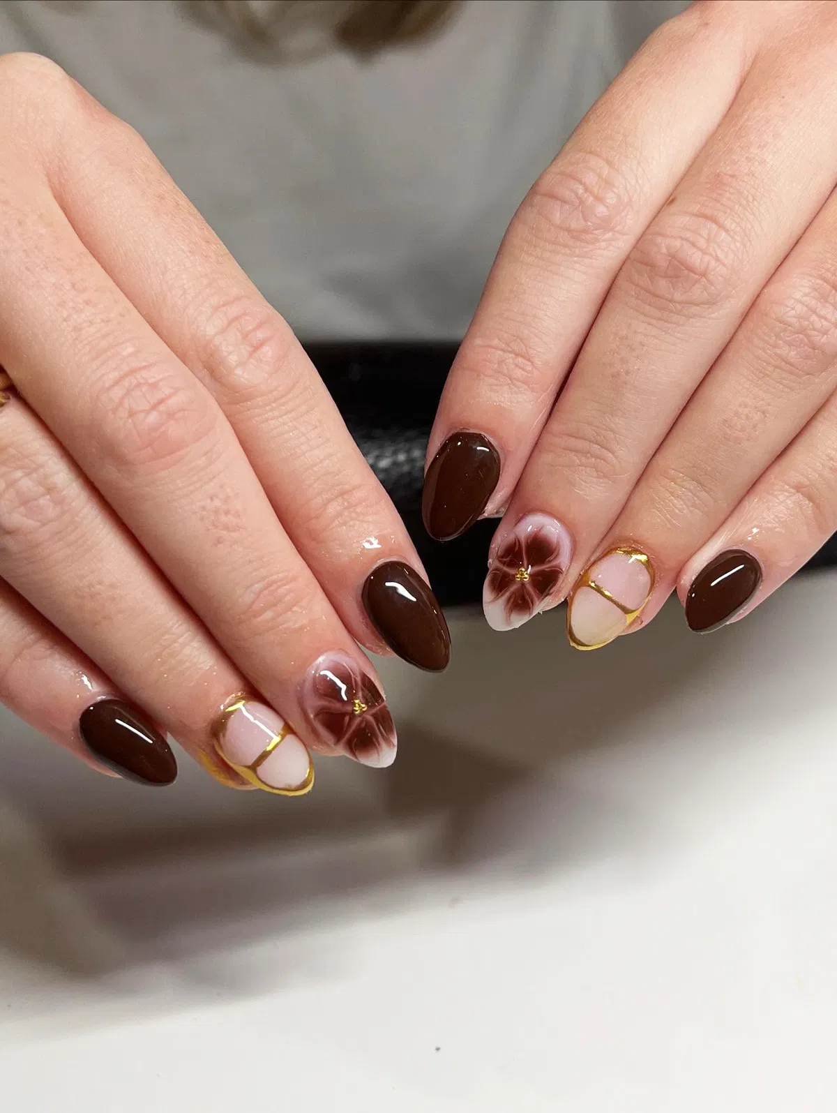Dark brown solids with floral and gold-outlined nude accents
