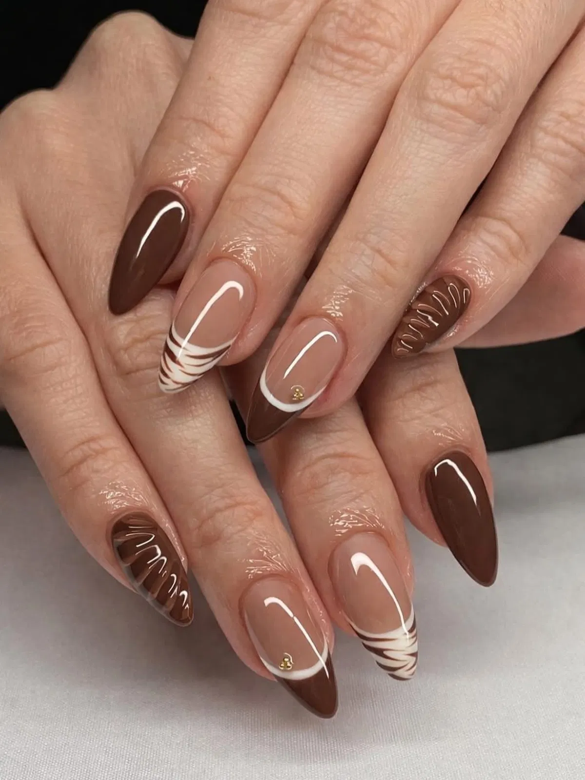 Brown and nude French tips with white swirl striping