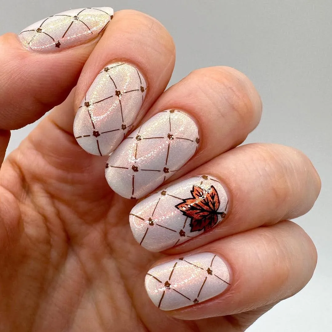 Pearly white grid nails with a single leaf accent