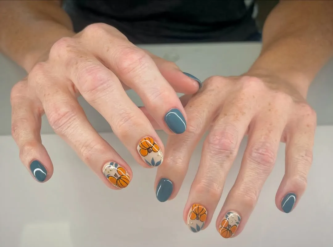 Slate-gray nails with pumpkin accents on beige