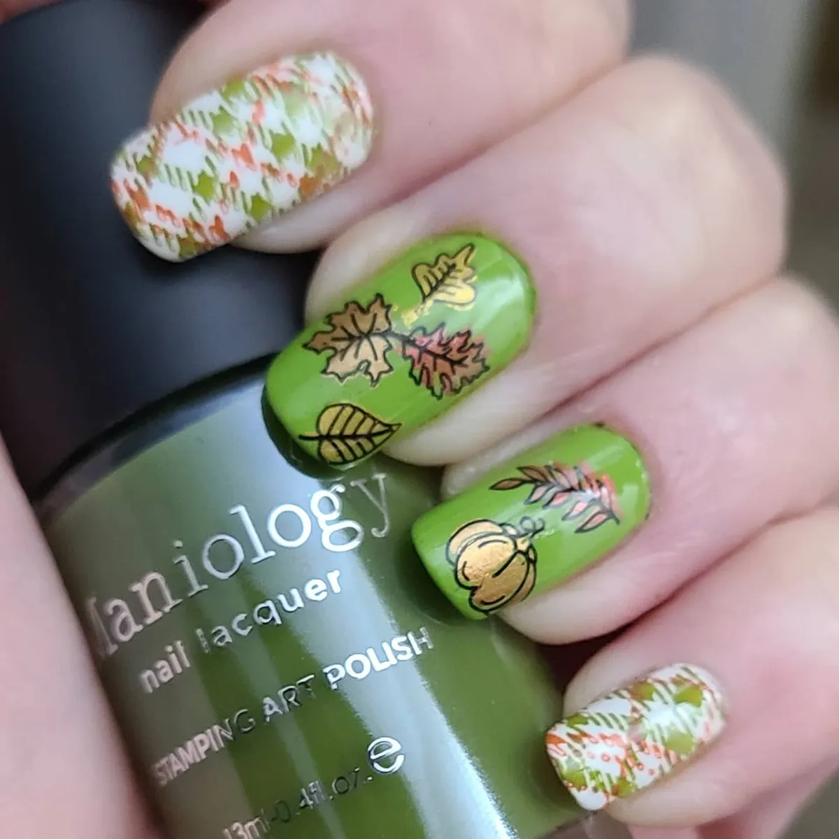 Green botanical nails with patterned cream accents