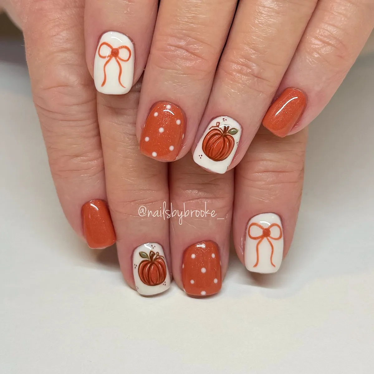 White-and-orange set with bows, polka dots, and pumpkin accent
