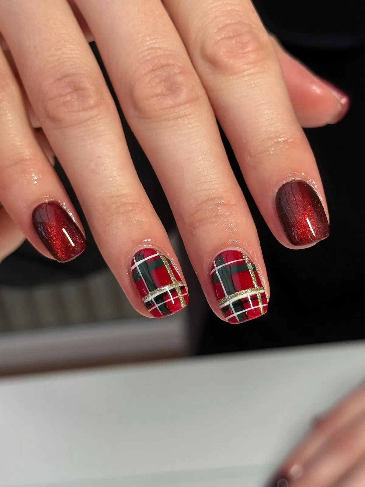 Shimmery red with plaid accent nails