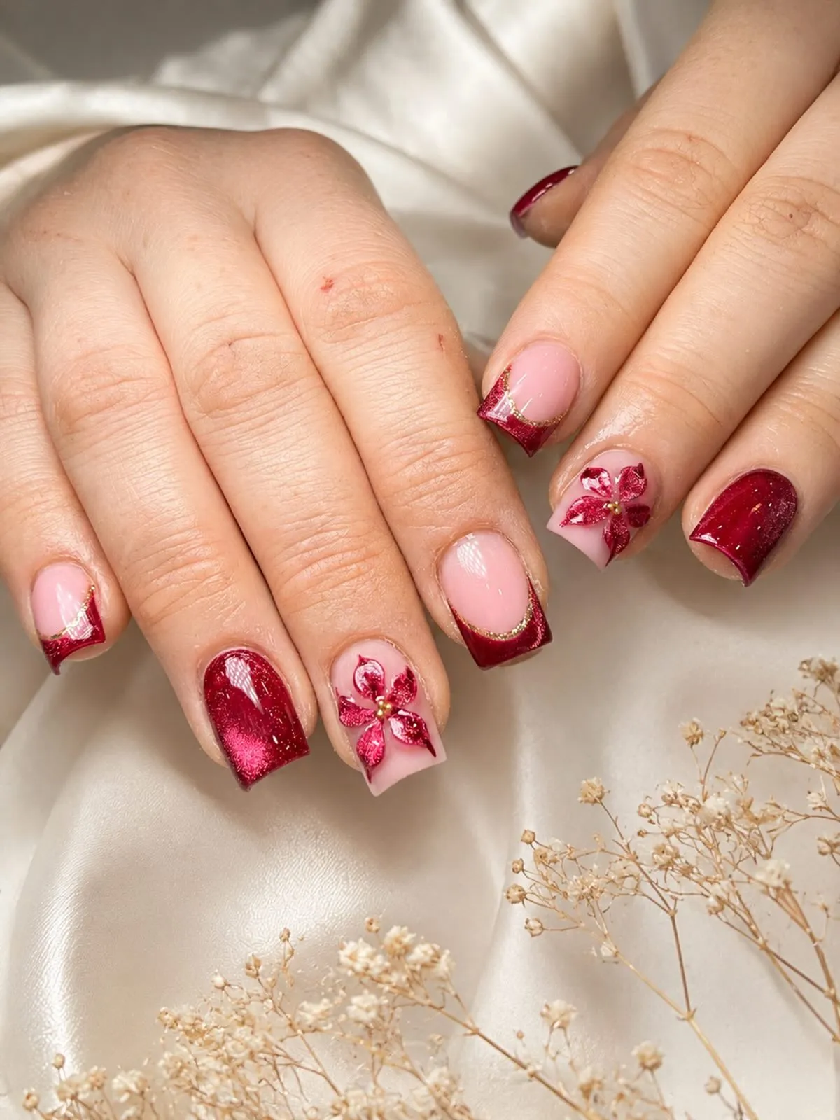 Red glitter and French tips with 3D floral accents