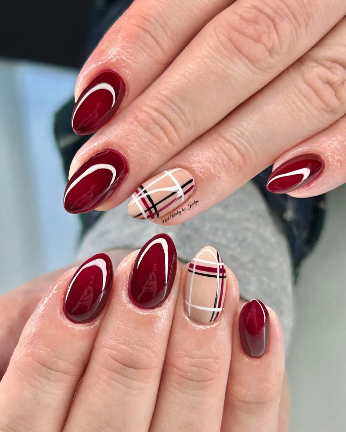 Burgundy almond nails with white swoosh and plaid accents