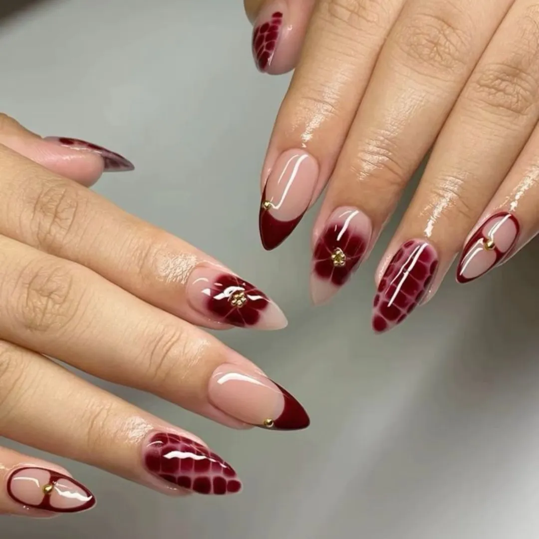 Nude-and-red French tips with floral and patterned accents