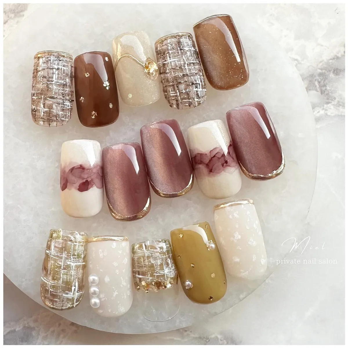 Mixed neutral ombre tips with metallic grid and pearl accents