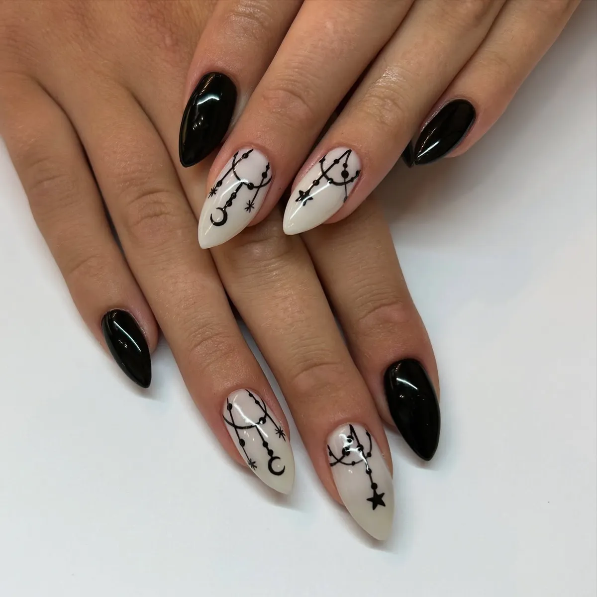 Black Stilettos with White Nails and Hanging Celestial Line Art