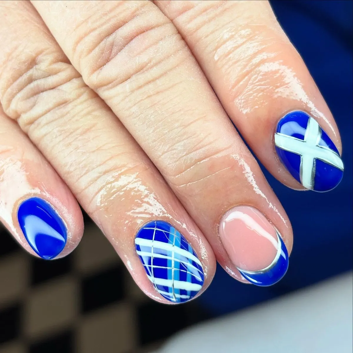 Royal blue graphics: plaid grid, curved lines, and bold white cross