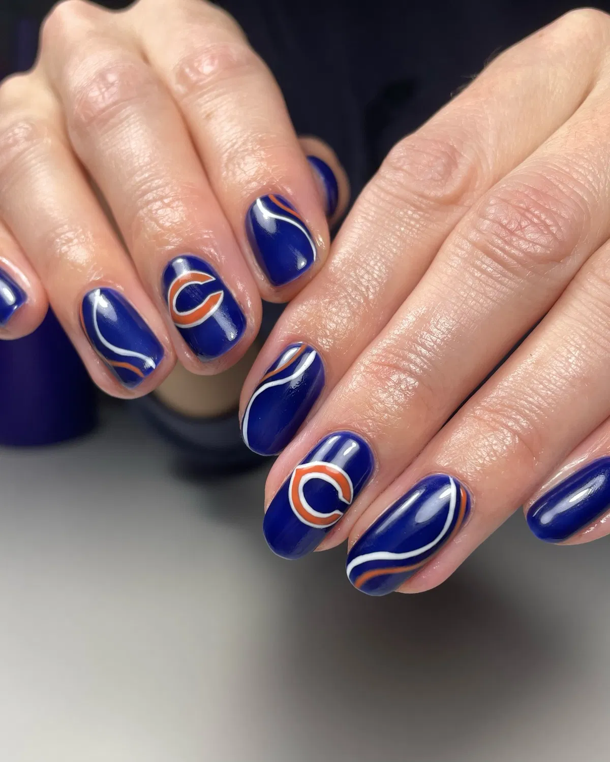 Deep blue set with orange-and-white wave lines and 'C' motifs