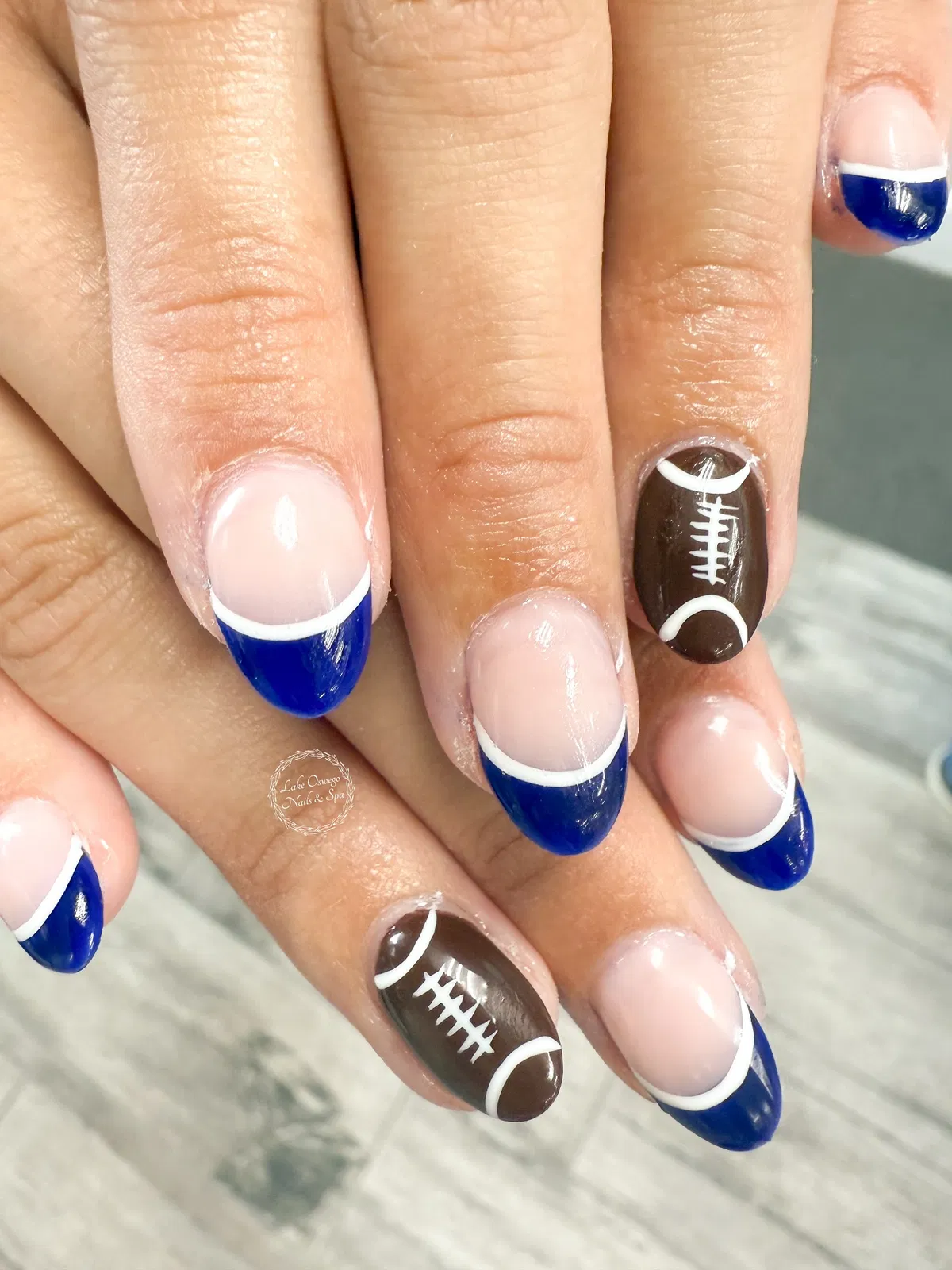 Blue French tips with brown football accent nails