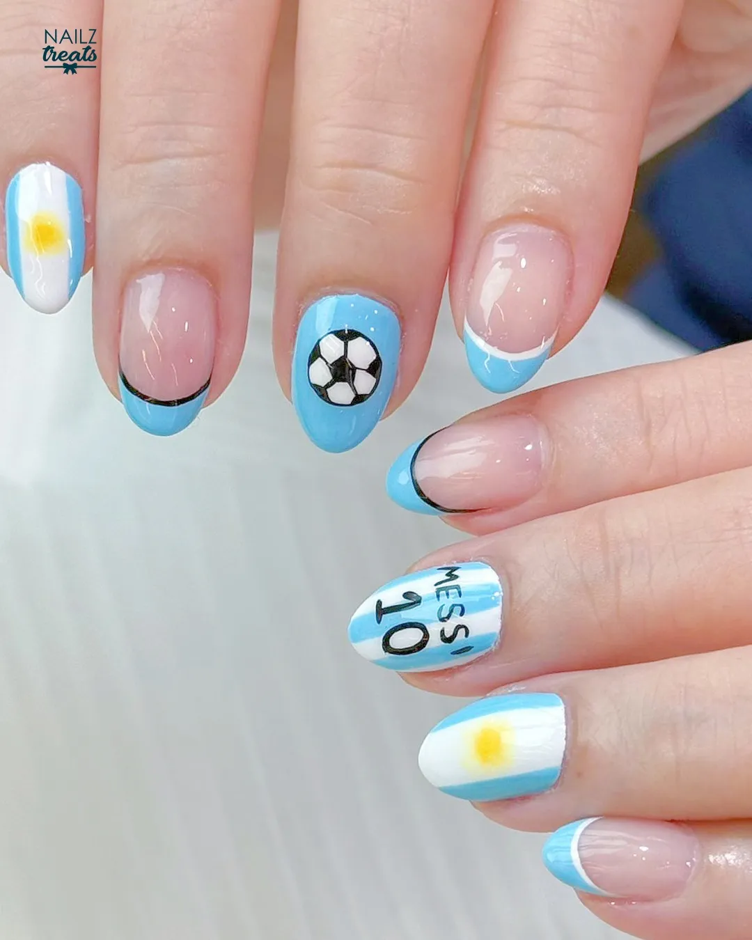 Light blue French tips with soccer ball and “MESSI 10” text