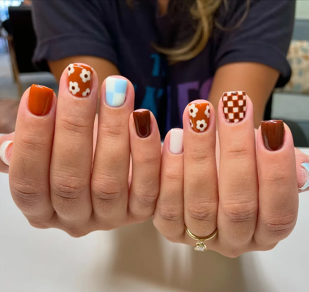 Brown and orange mix with florals, checkerboard, and a blue check accent