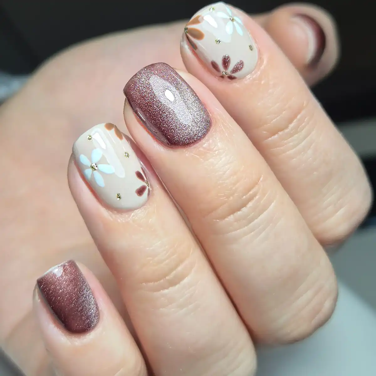 Mauve-brown shimmer with cream floral nails and gold studs
