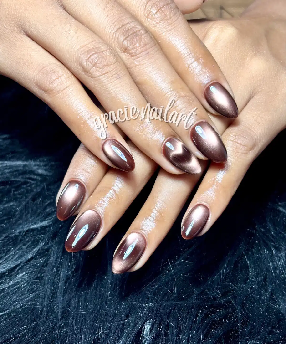 Glossy brown metallic nails with centered reflective band