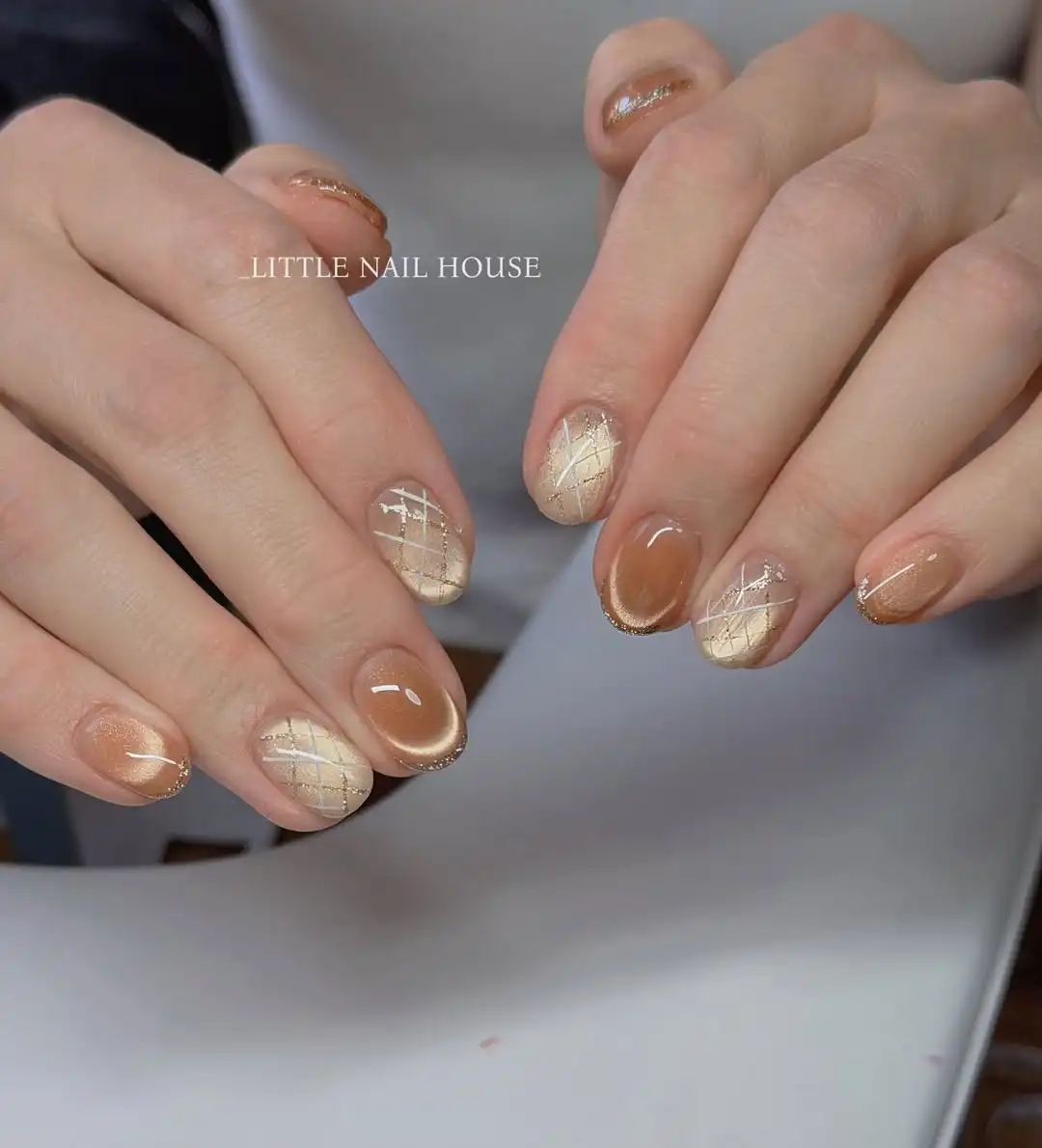 Beige crisscross accents with warm brown reflective nails