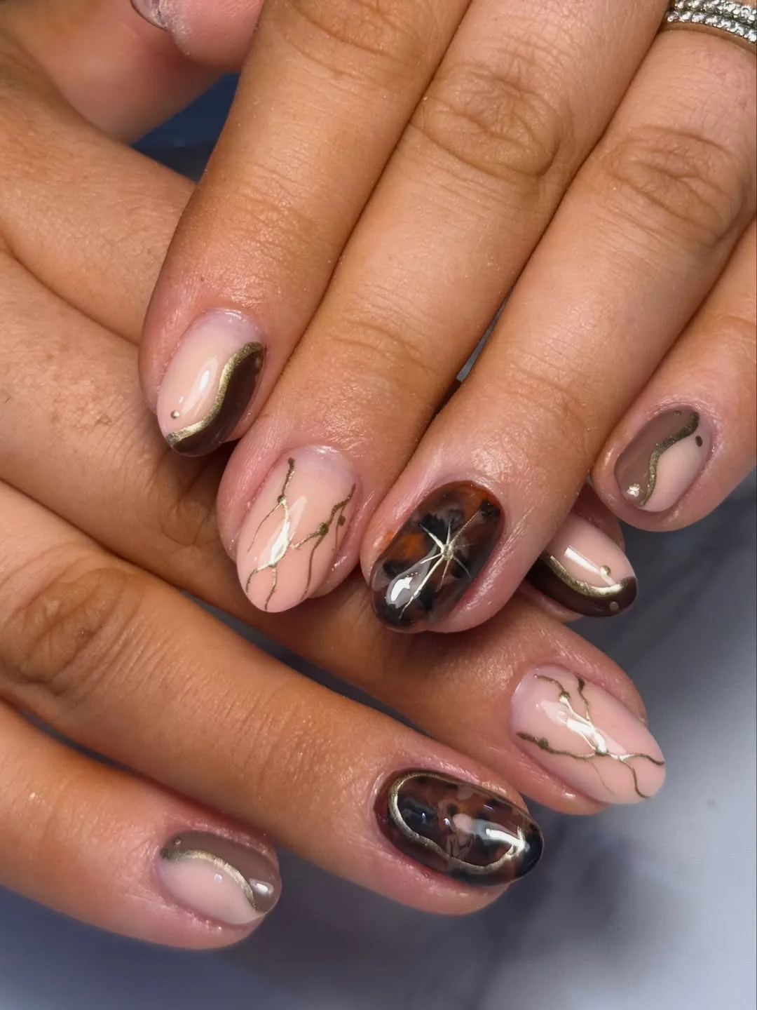Nude base with gold veining and marbled accents