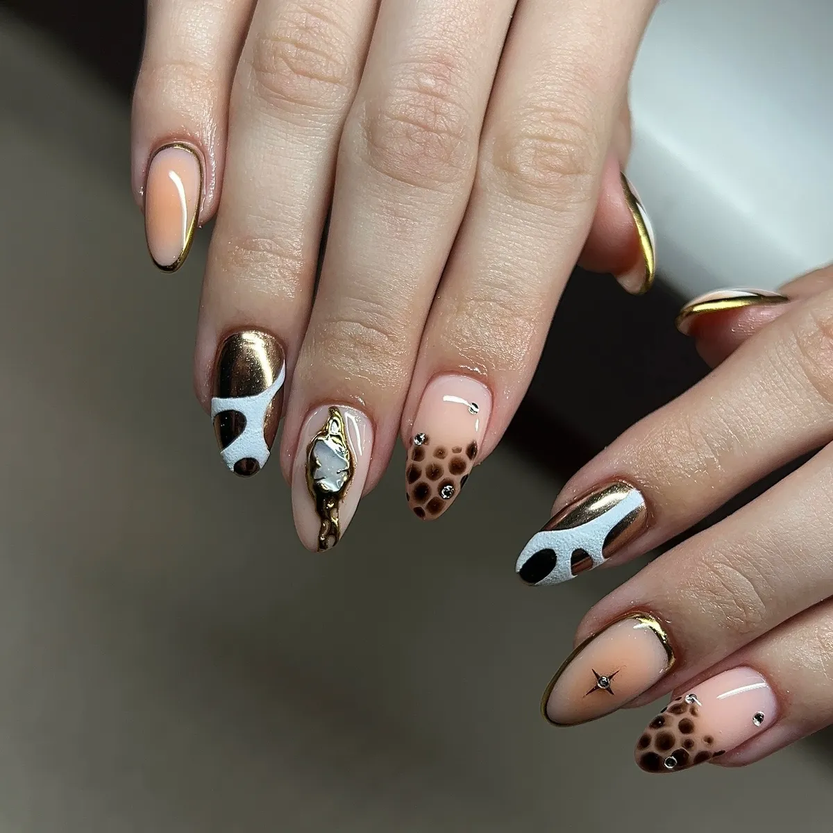 Gold-brown metallic mix with abstract white patches and studs