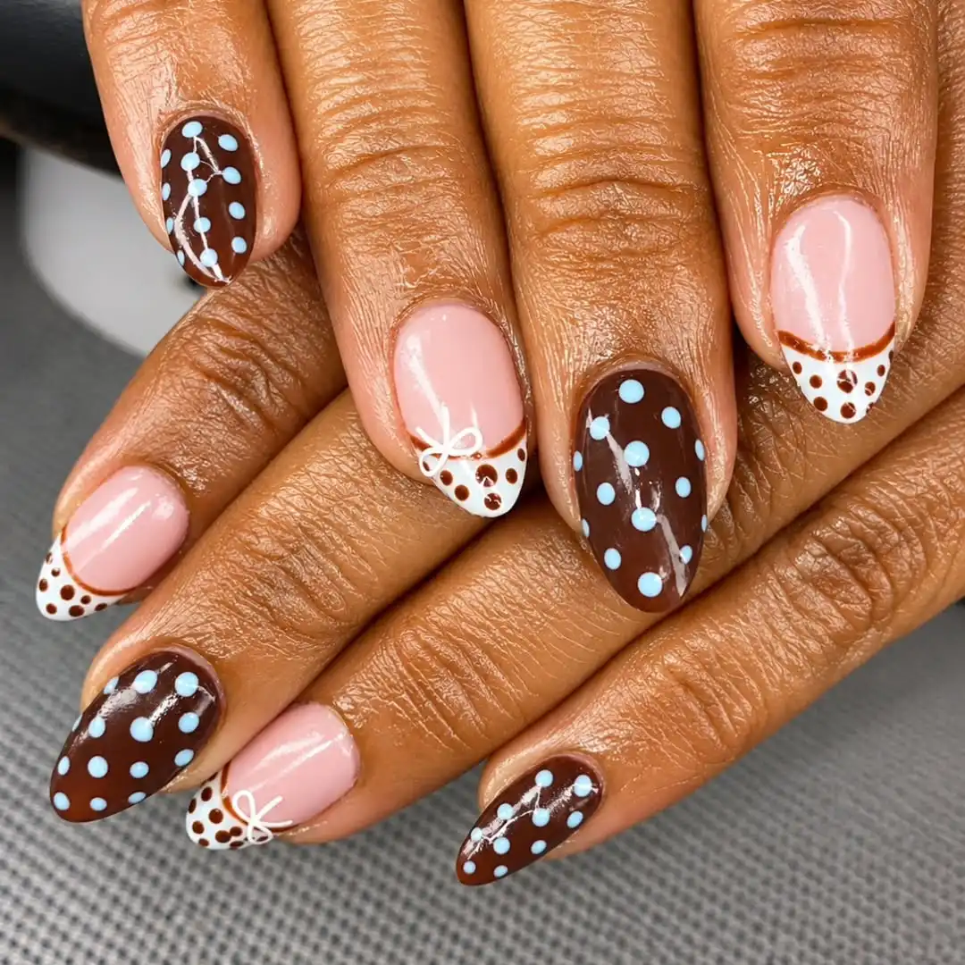 Polka-dot brown and white French tips with blue accents