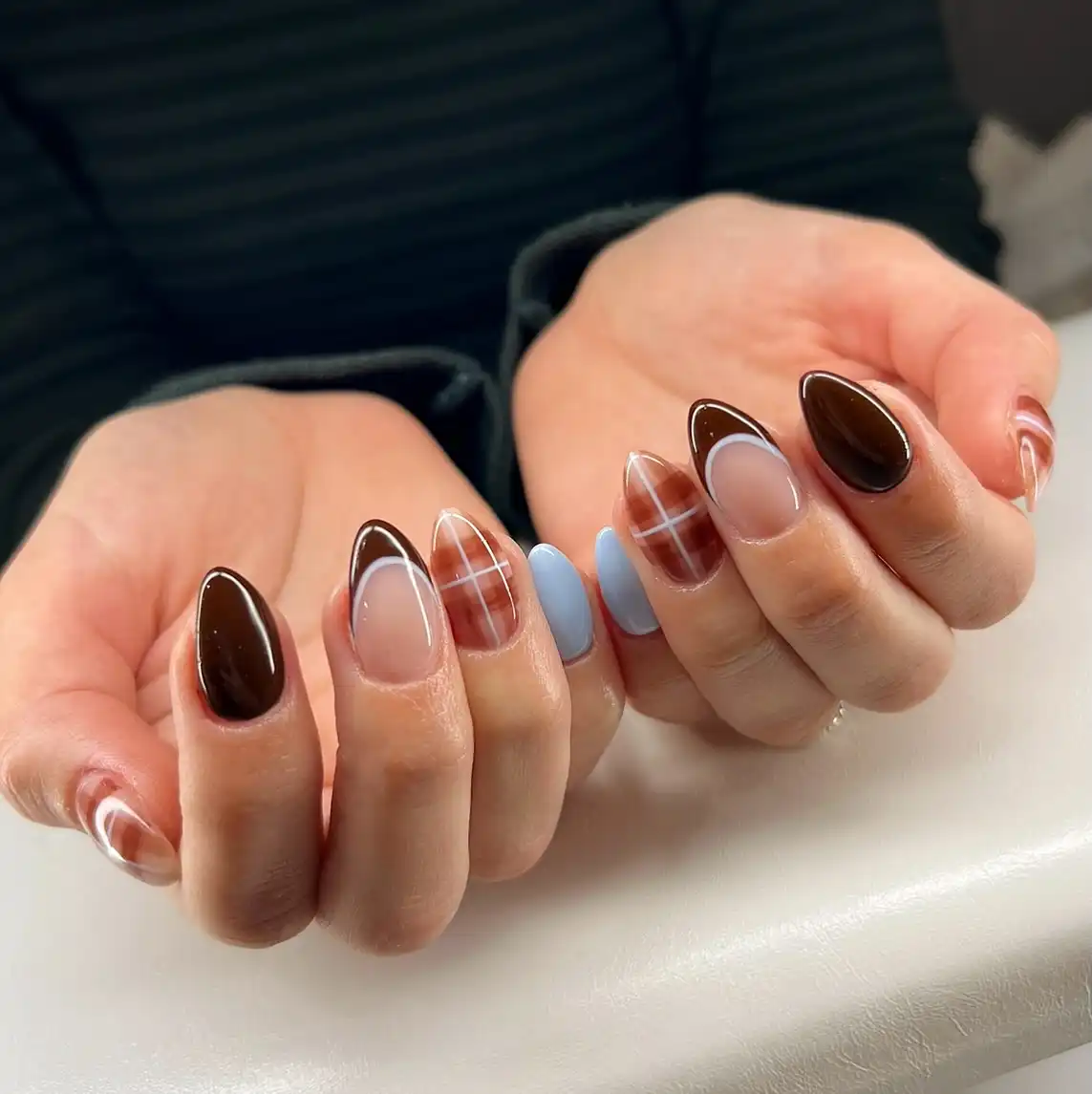 Brown outline French tips with grid art and light-blue accents