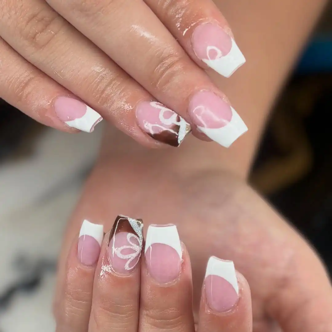 White French tips with a brown-and-white swirl accent