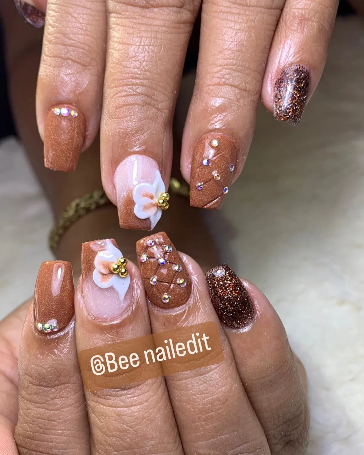 Brown shimmer square nails with rhinestones and 3D flower